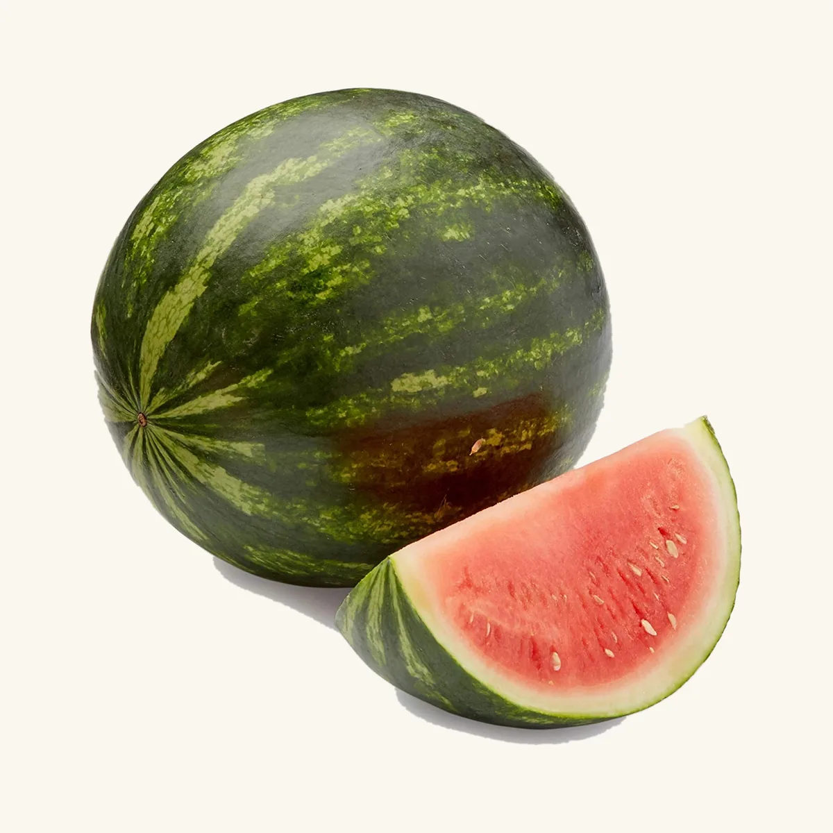 A whole watermelon with a cut slice